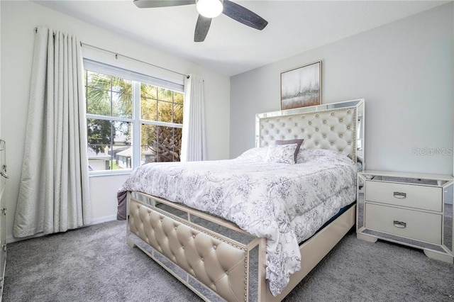 carpeted bedroom with ceiling fan and baseboards
