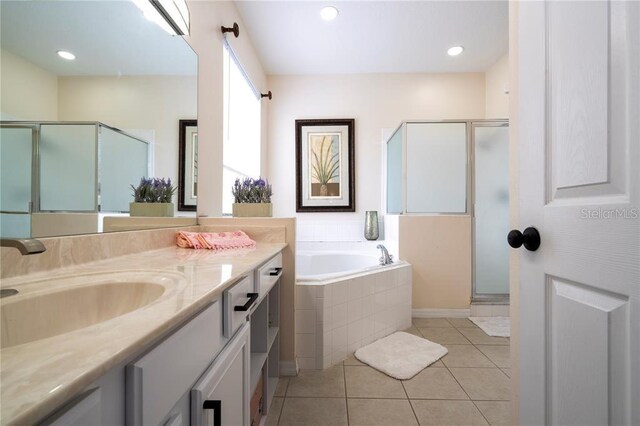 bathroom with tile patterned flooring, separate shower and tub, and vanity