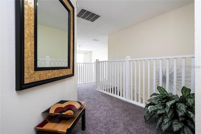 hall with visible vents and carpet