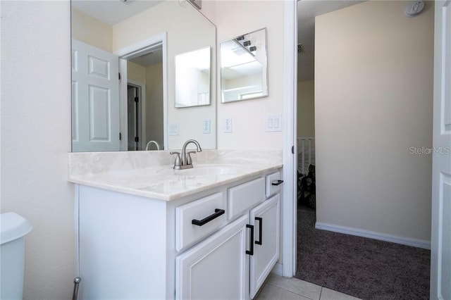 bathroom featuring vanity, toilet, and tile patterned flooring