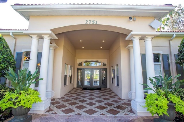 entrance to property with stucco siding and french doors