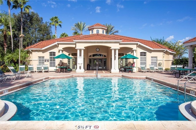 view of pool featuring french doors and a patio area