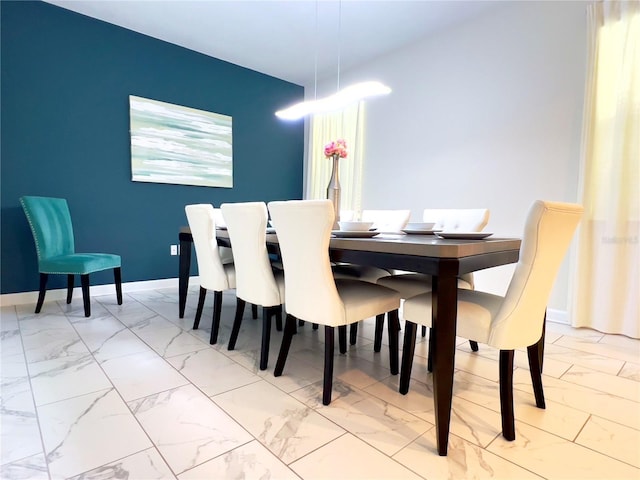 dining room with baseboards and marble finish floor