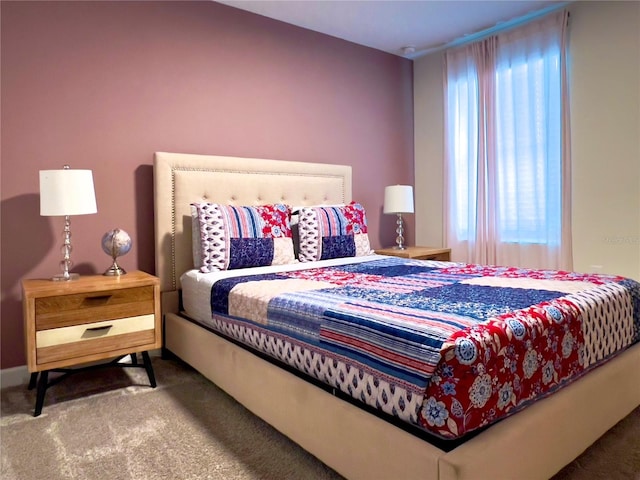 bedroom featuring carpet flooring and multiple windows