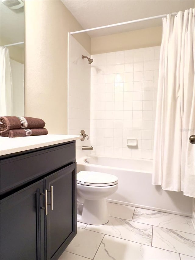 full bath featuring shower / bath combination with curtain, vanity, marble finish floor, and toilet