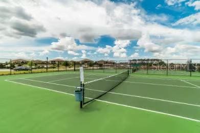 view of sport court featuring fence