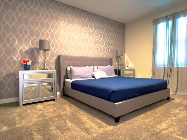 791 Pebble Beach Dr, Davenport, FL 33896 - bedroom featuring wallpapered walls, baseboards, an accent wall, and carpet