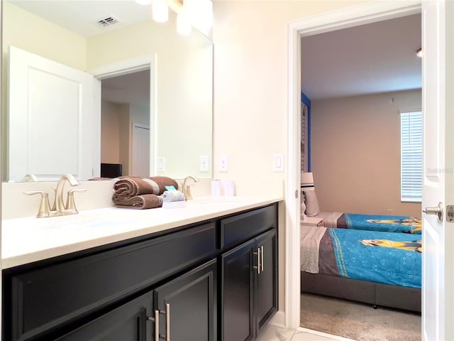 791 Pebble Beach Dr, Davenport, FL 33896 - full bathroom with visible vents, a sink, double vanity, and connected bathroom