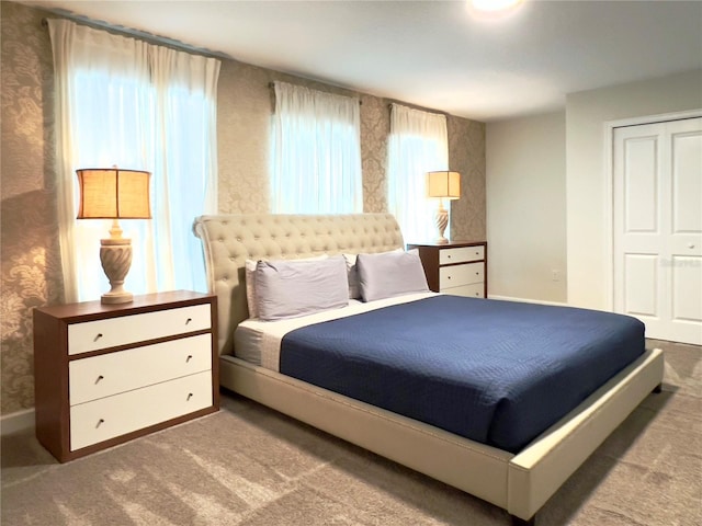 791 Pebble Beach Dr, Davenport, FL 33896 - carpeted bedroom with wallpapered walls, a closet, and baseboards