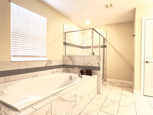 791 Pebble Beach Dr, Davenport, FL 33896 - bathroom with a bath, a shower stall, marble finish floor, and baseboards
