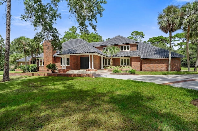 mediterranean / spanish home with a front yard