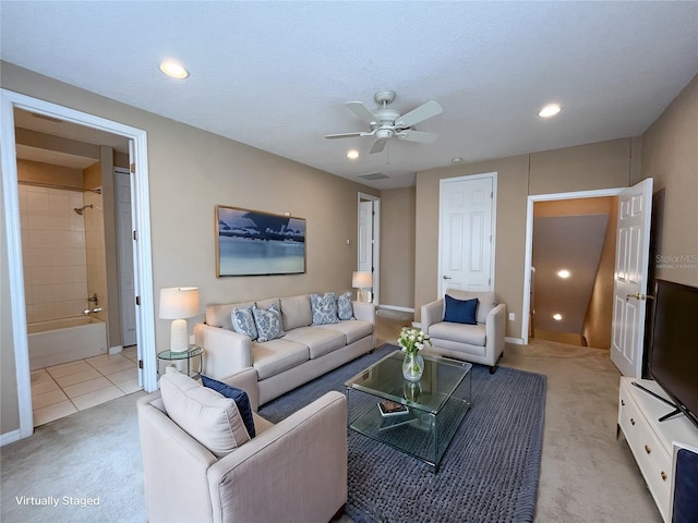 carpeted living room with ceiling fan