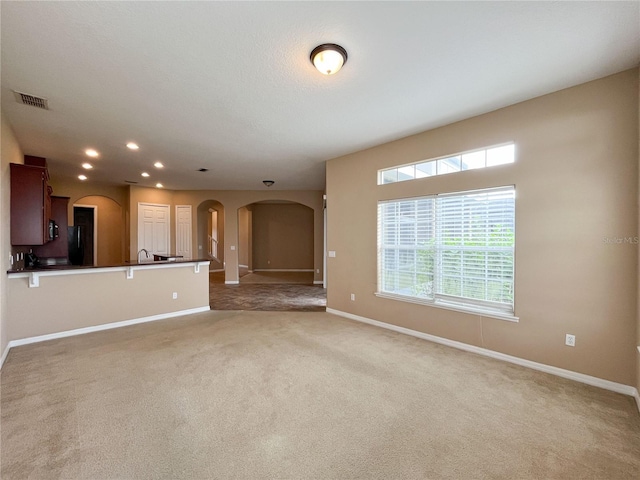 unfurnished living room featuring carpet flooring