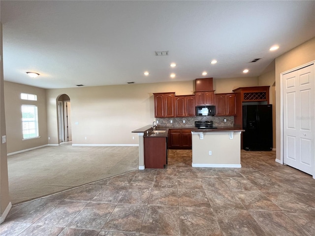 kitchen with black appliances, sink, decorative backsplash, a kitchen island, and carpet floors