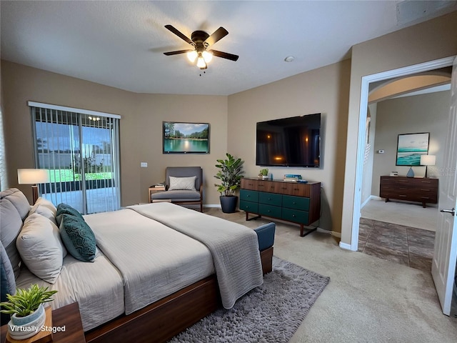 carpeted bedroom featuring ceiling fan and access to exterior