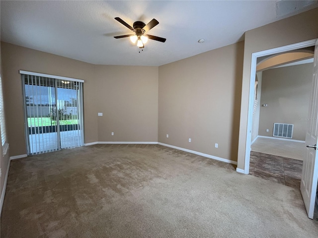 empty room with light colored carpet and ceiling fan