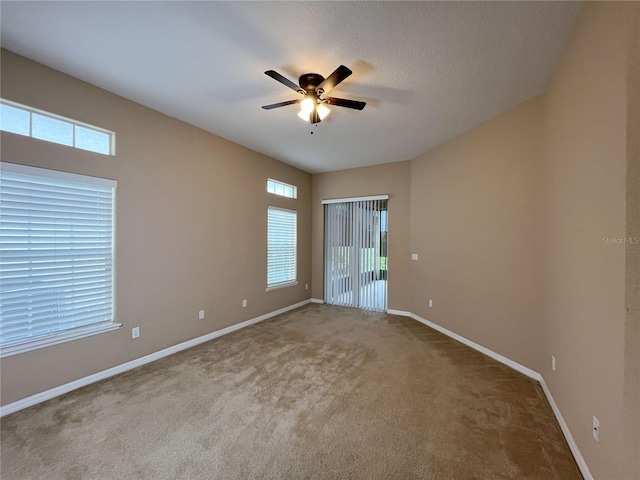 spare room with carpet flooring and ceiling fan