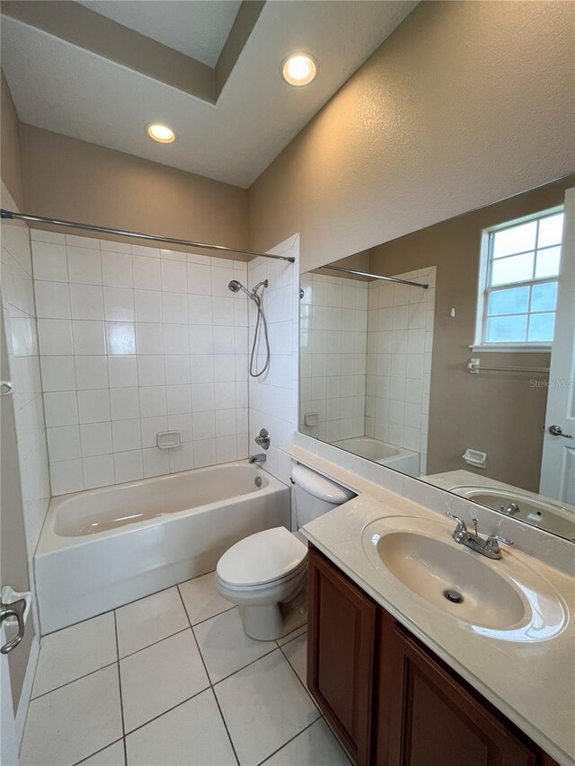 full bathroom with tile patterned flooring, vanity, toilet, and tiled shower / bath