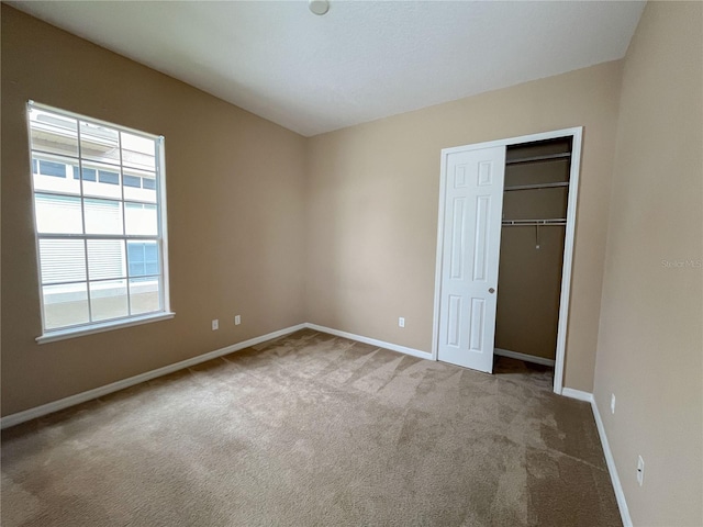 unfurnished bedroom with carpet and a closet