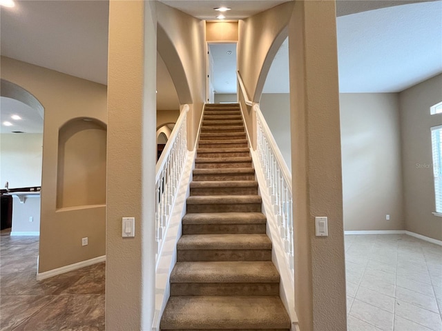 stairs featuring tile patterned floors