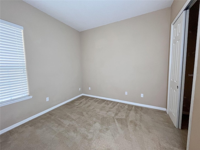 unfurnished bedroom featuring light colored carpet