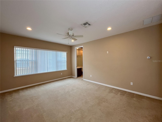 carpeted empty room featuring ceiling fan