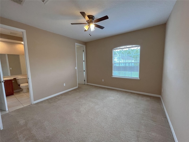 empty room with light colored carpet and ceiling fan