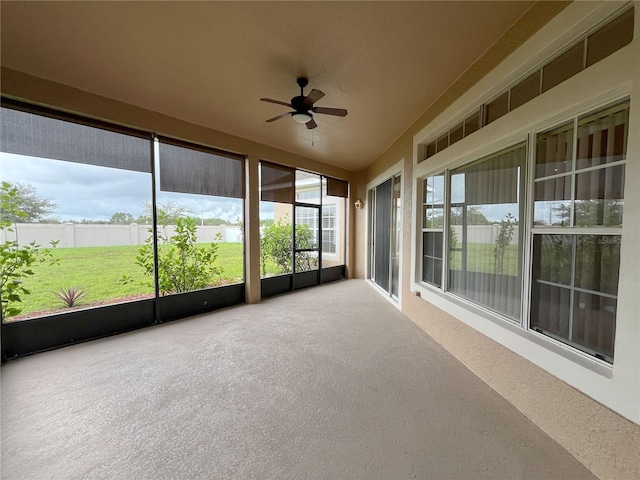 unfurnished sunroom with ceiling fan and lofted ceiling