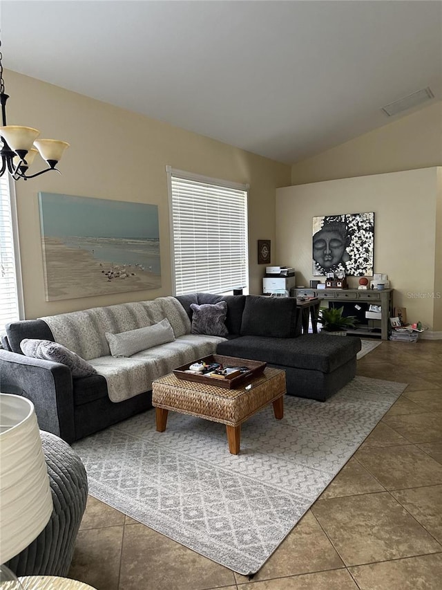 living room featuring an inviting chandelier and vaulted ceiling