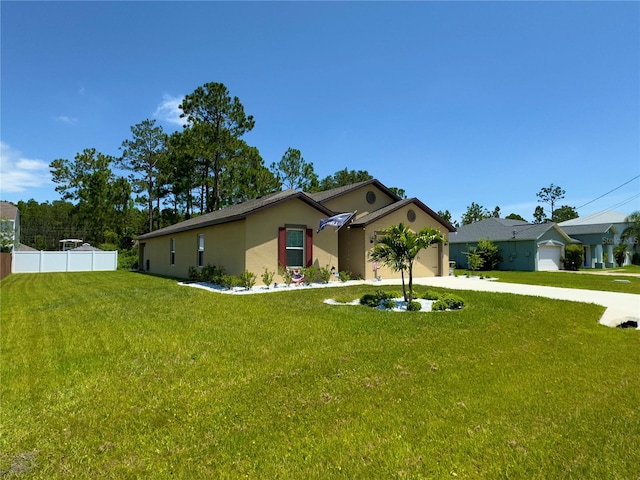 ranch-style home featuring a garage and a front yard