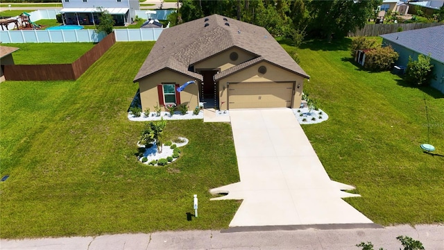 view of front facade with a garage and a front yard