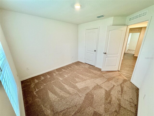 unfurnished bedroom with a closet and carpet floors