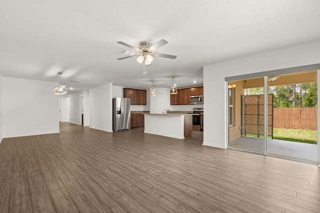 8 Slipper Flower Path E, Palm Coast, FL 32164 - unfurnished living room featuring ceiling fan and dark wood-style floors