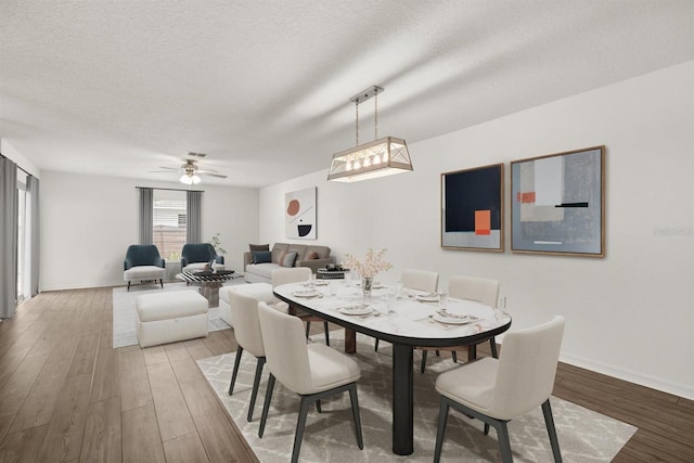 8 Slipper Flower Path E, Palm Coast, FL 32164 - dining area featuring light wood-style flooring, ceiling fan, a textured ceiling, and baseboards