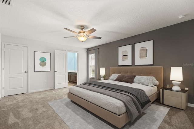8 Slipper Flower Path E, Palm Coast, FL 32164 - bedroom with light carpet, baseboards, connected bathroom, and a textured ceiling