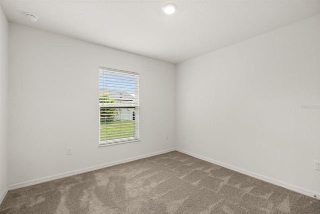 8 Slipper Flower Path E, Palm Coast, FL 32164 - spare room featuring carpet, baseboards, and a smoke detector
