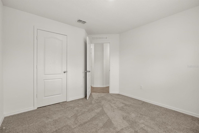 8 Slipper Flower Path E, Palm Coast, FL 32164 - unfurnished bedroom featuring carpet and baseboards