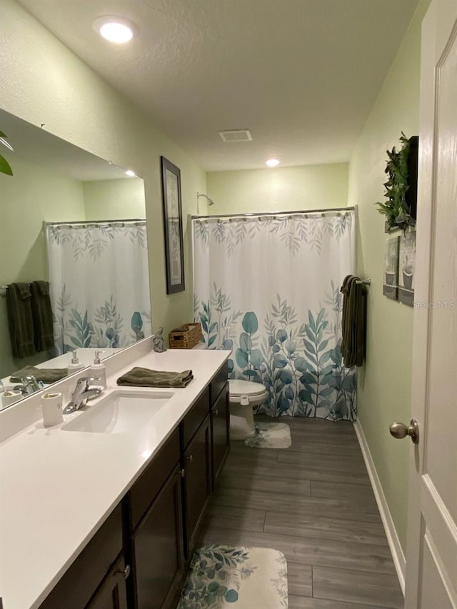 8 Slipper Flower Path E, Palm Coast, FL 32164 - bathroom with wood finished floors, vanity, toilet, and a shower with curtain