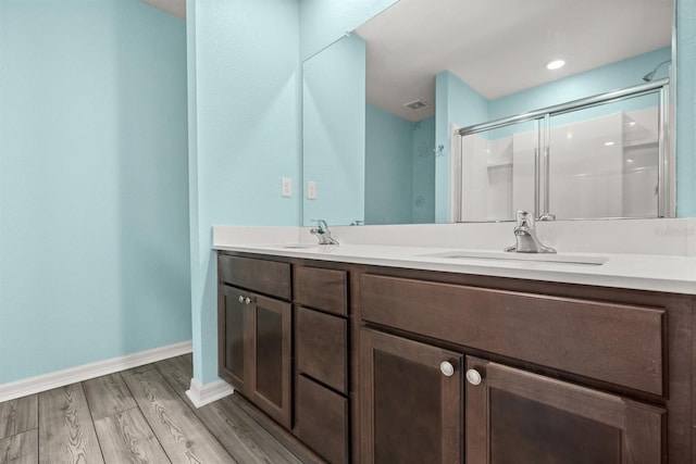 8 Slipper Flower Path E, Palm Coast, FL 32164 - full bathroom with a stall shower, wood finished floors, double vanity, and baseboards