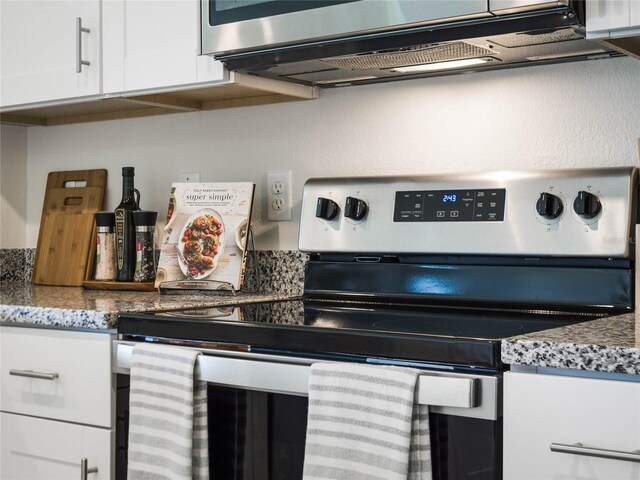 kitchen with stainless steel appliances and white cabinets