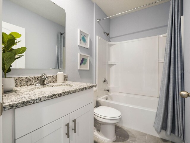 full bathroom featuring shower / bath combo with shower curtain, tile patterned flooring, toilet, and vanity