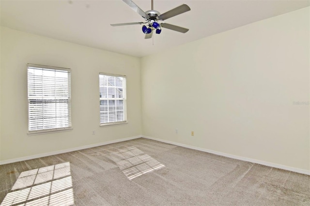 spare room featuring ceiling fan and light carpet