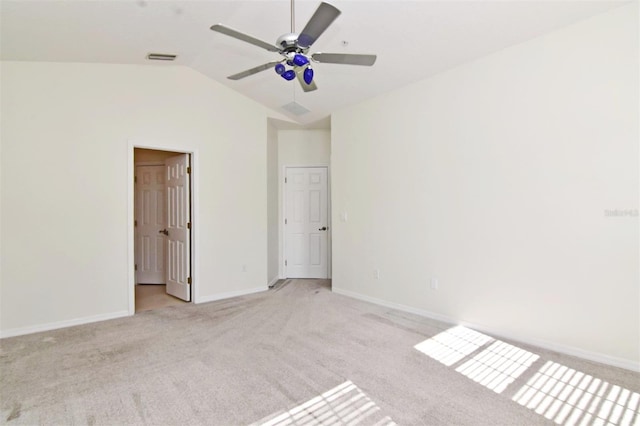 unfurnished bedroom with ceiling fan, light colored carpet, and vaulted ceiling