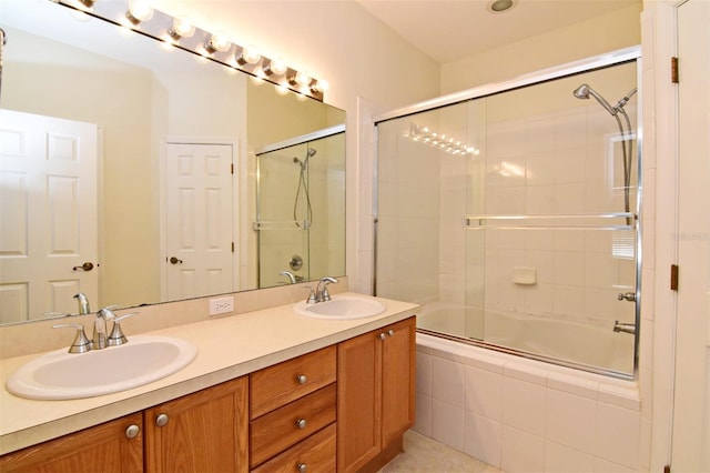 bathroom featuring shower / bath combination with glass door and vanity