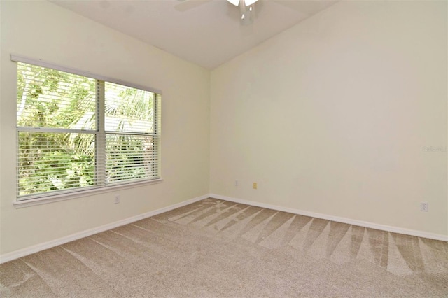 carpeted empty room with lofted ceiling and ceiling fan