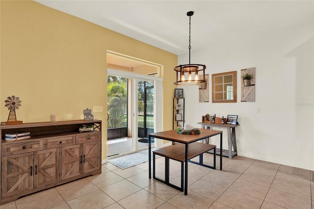 dining space featuring light tile patterned floors and baseboards