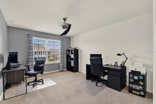 carpeted office space featuring a textured ceiling and baseboards