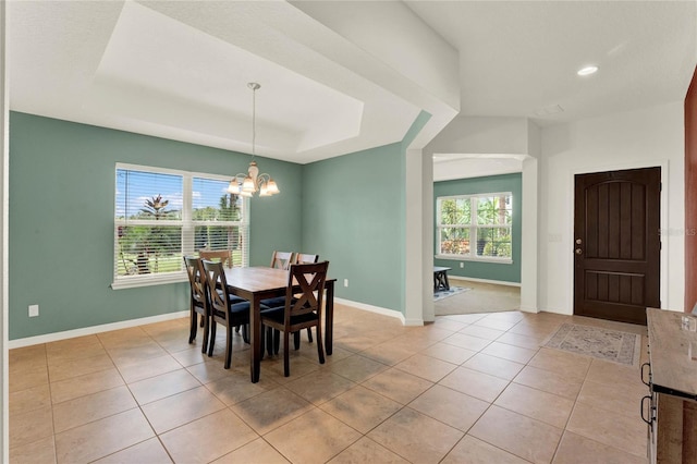 dining area with light tile patterned floors, recessed lighting, a raised ceiling, a chandelier, and baseboards