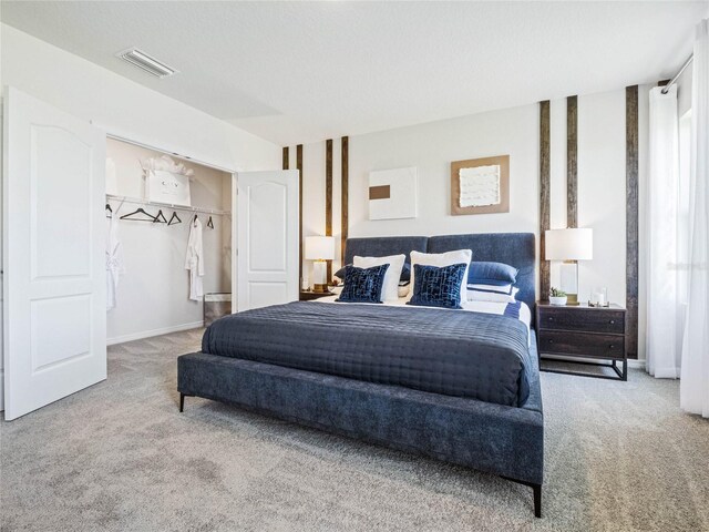 carpeted bedroom featuring a textured ceiling and a closet