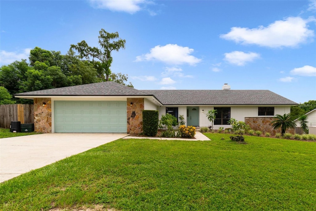 ranch-style home featuring a garage and a front yard